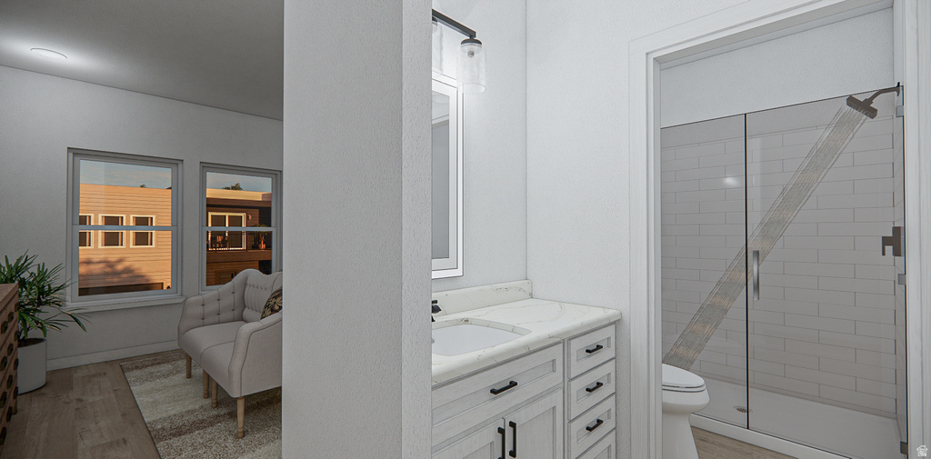 Bathroom vanity featuring a single basin, stone countertop, and light wood-finish cabinetry with dark hardware
