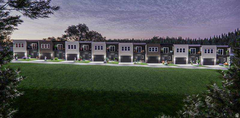 Modern multi-story townhomes with dark garage doors and contrasting facade colors