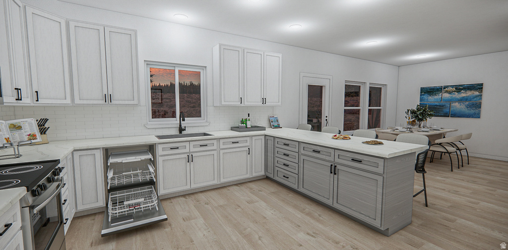 Modern kitchen featuring white shaker-style cabinetry, a built-in dishwasher, an island with gray cabinetry, a single basin sink with a black faucet, and wood-finish flooring