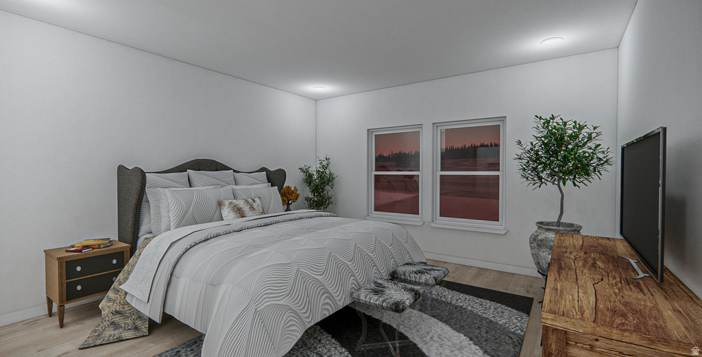 Bright bedroom with light wood-finish flooring and recessed ceiling lighting