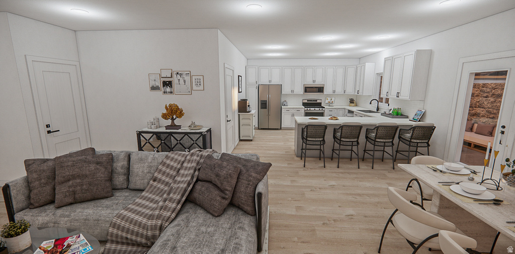 Open-concept living space featuring wood-finish flooring, recessed lighting, and white walls
