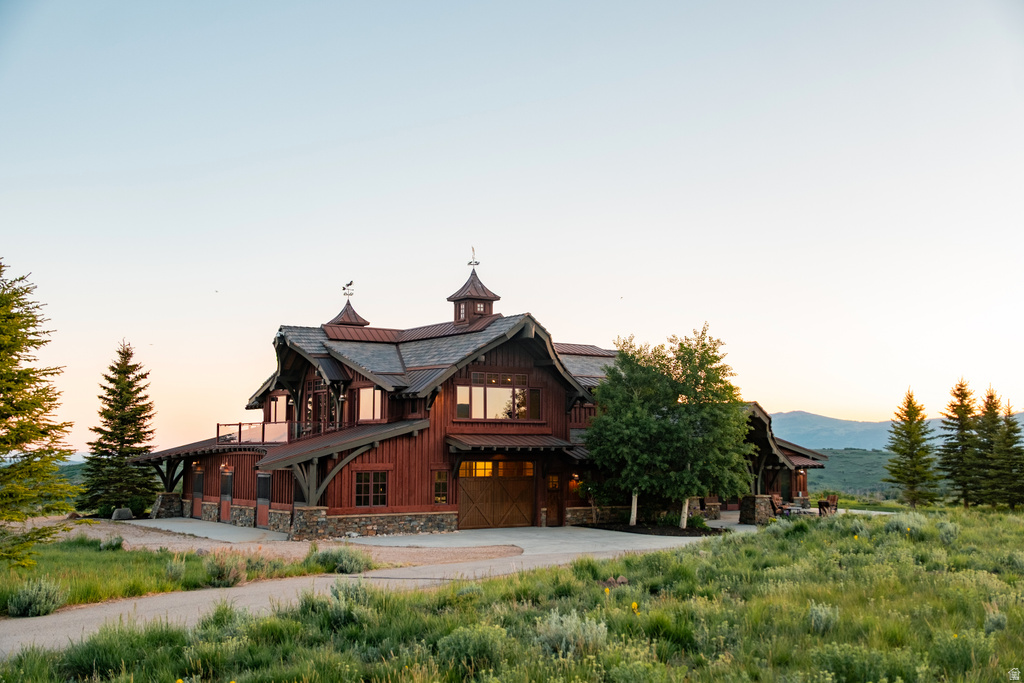 Rustic wood-sided dwelling featuring a multi-gabled roofline and stone accents