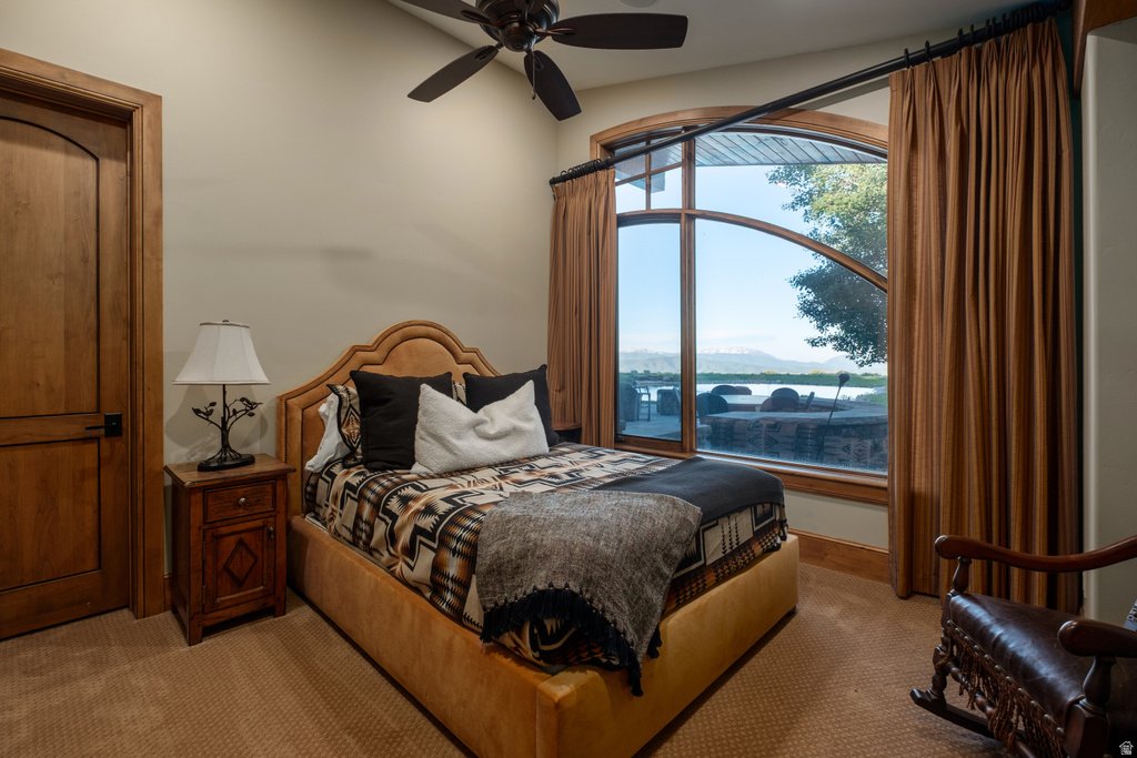 Arched picture window framing a serene water feature and distant mountains