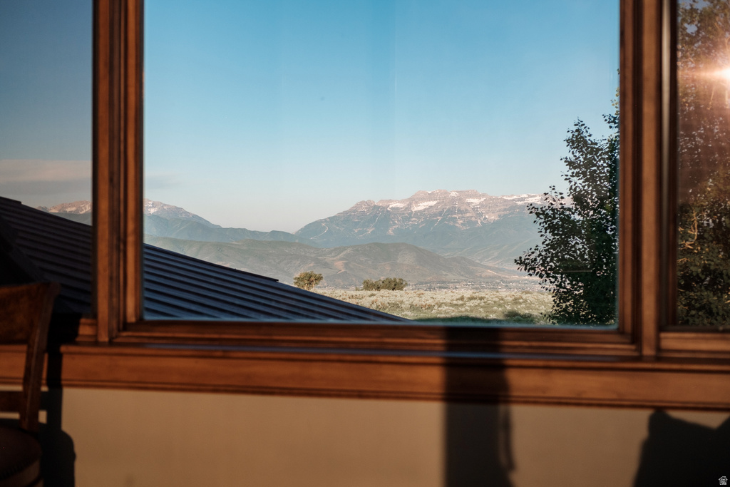 Wood-framed window offering expansive mountain and valley scenery