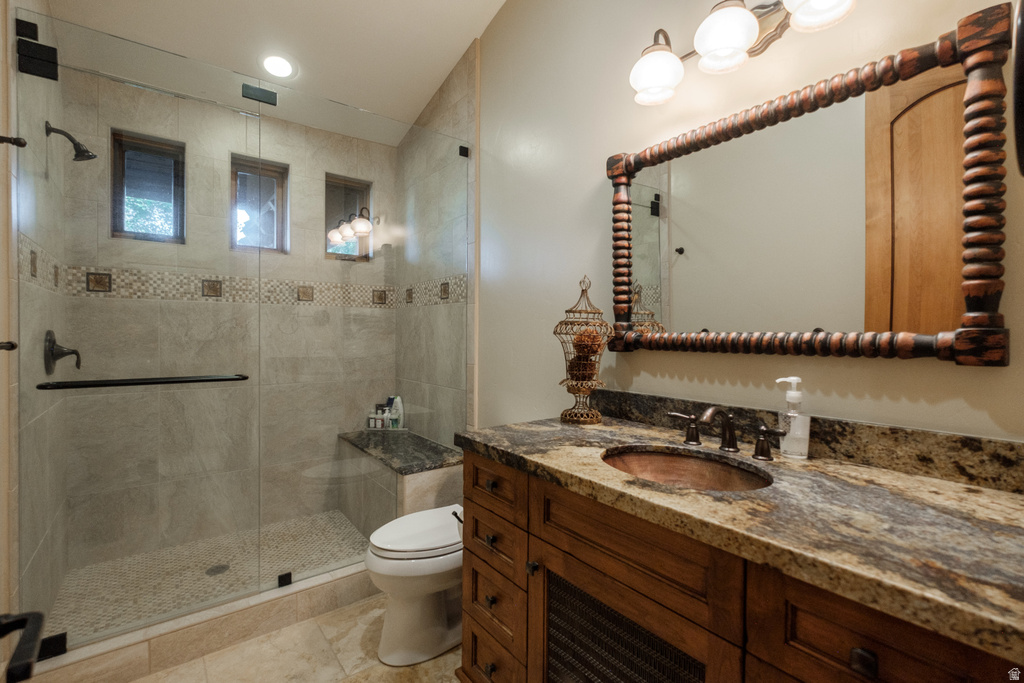 Bathroom featuring a walk-in shower with glass enclosure, integrated bench, and mosaic tile accents