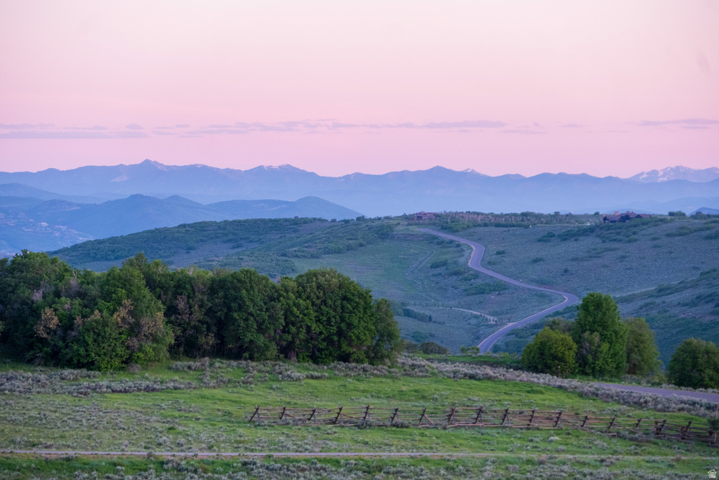 Expansive mountain landscape with a winding paved road