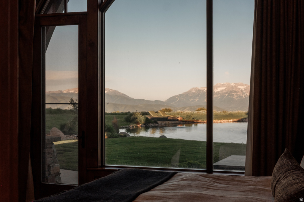 Expansive window wall with dark wood framing, offering panoramic mountain scenery