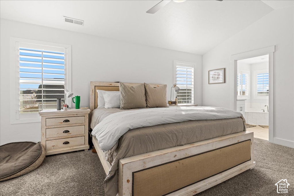 Carpeted bedroom with vaulted ceiling and recessed lighting