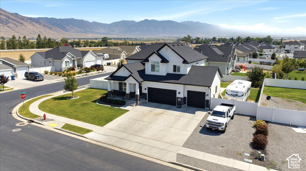 Two-story residence with a black shingle roof, white siding, and stone accents