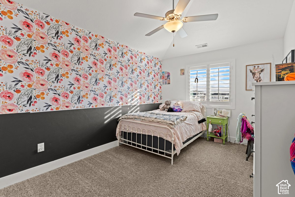 Bedroom featuring a two-tone wall design with floral wallpaper and a solid lower section