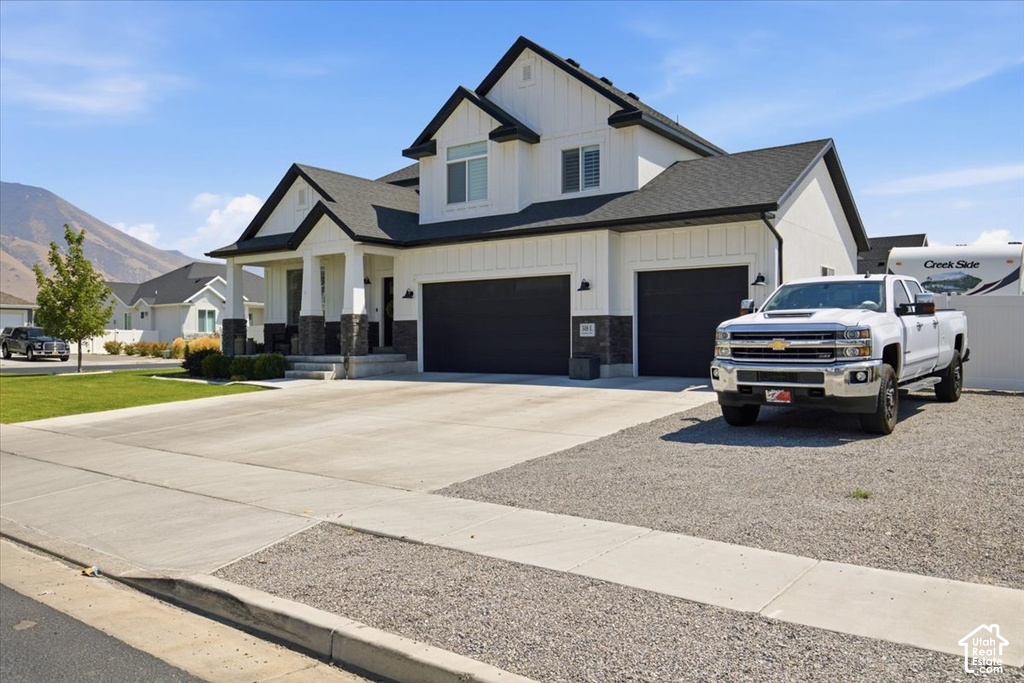 Contemporary-style exterior with black trim, a covered entry, and a two-car garage