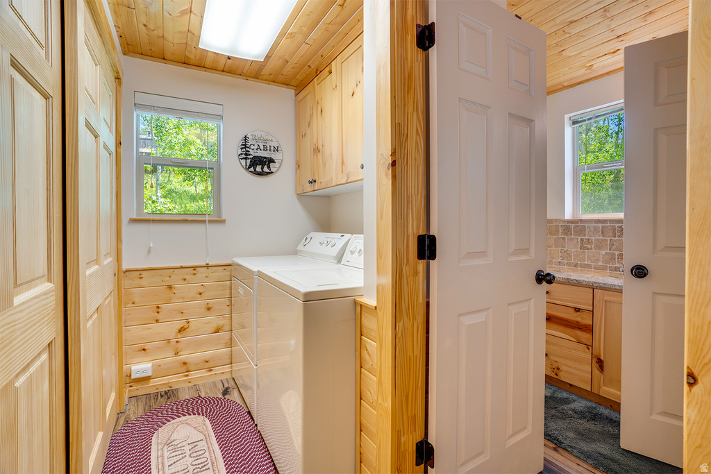 Functional utility room featuring wood-finish paneling, a ceiling-mounted fluorescent light fixture, and a window with natural light