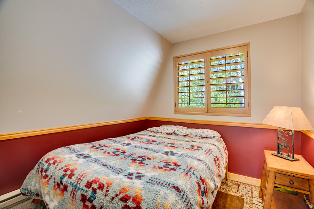 Neutral wall tones with a deep red accent wall and wood trim