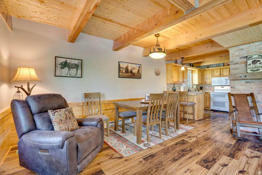 Vaulted wood-paneled ceilings with exposed beams complement the wood-finish flooring