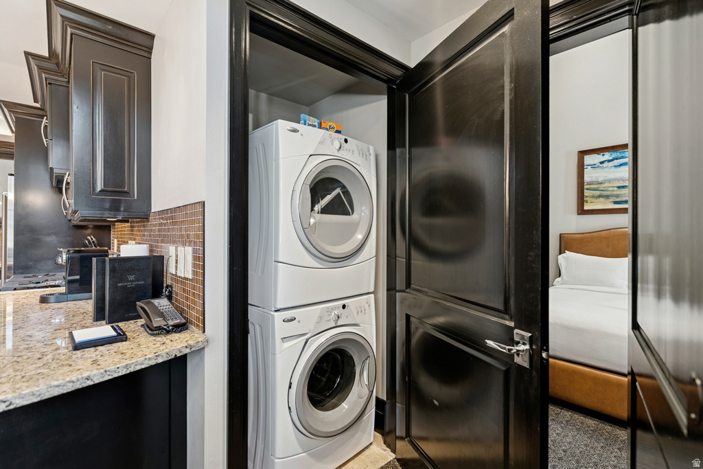 Stackable washer and dryer unit within a dedicated closet