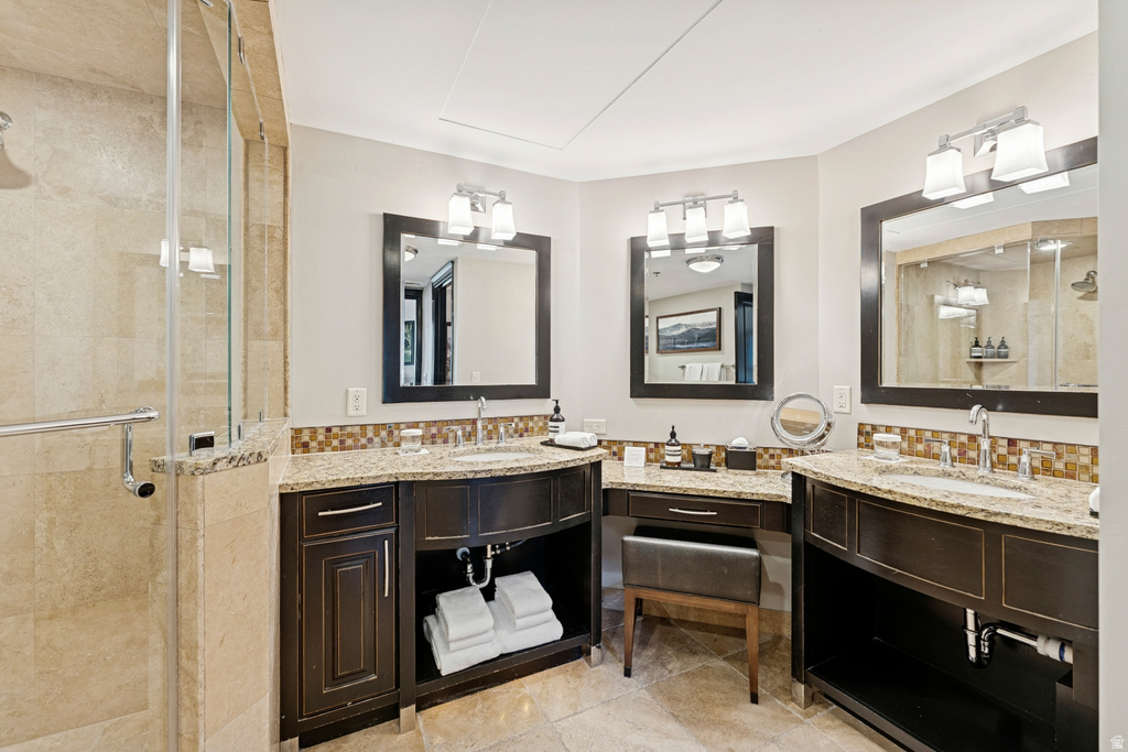 Dual vanity with curved dark wood cabinetry and integrated sinks