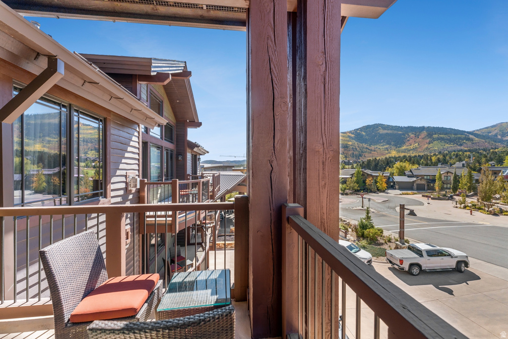 Private balcony featuring robust wood structural posts and a metal railing system