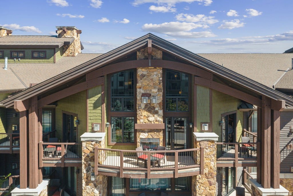 Mountain-style residence featuring a prominent gabled roofline and exposed timber framing