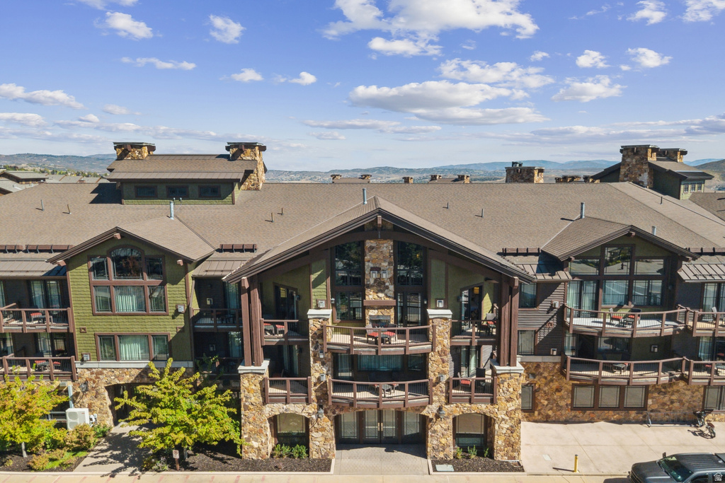 Multi-story building featuring natural stone and wood siding