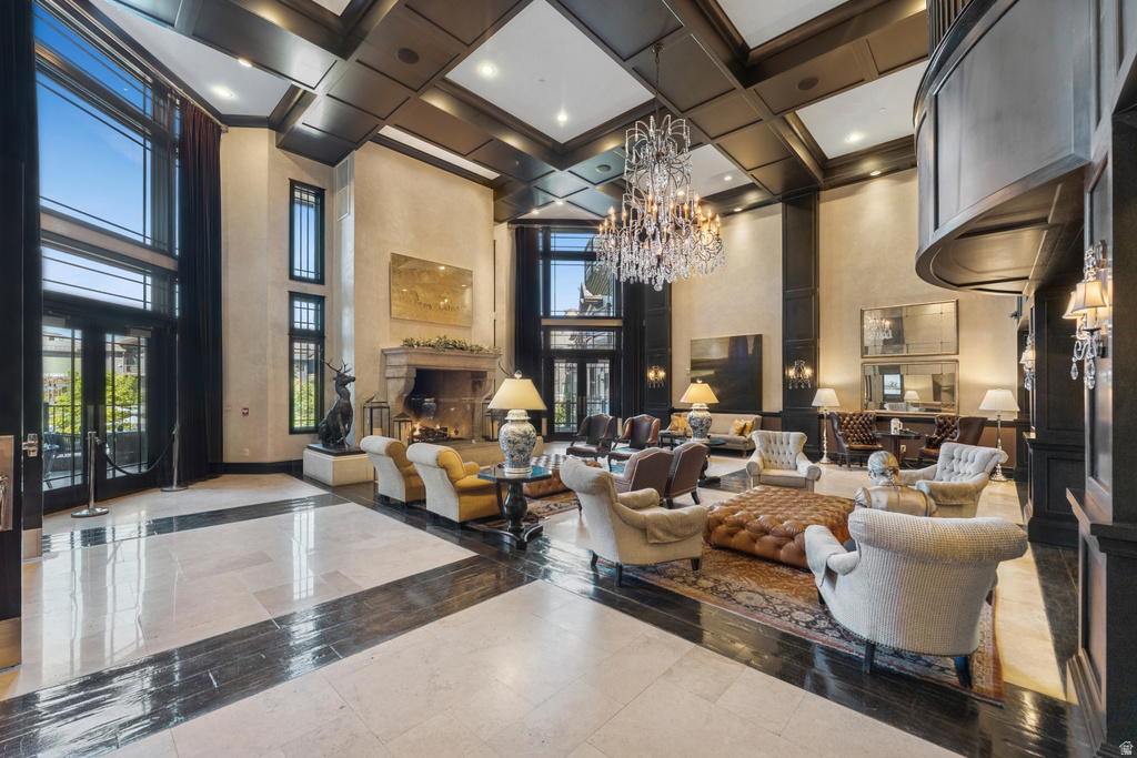 Grand reception area featuring a coffered ceiling and a large crystal chandelier