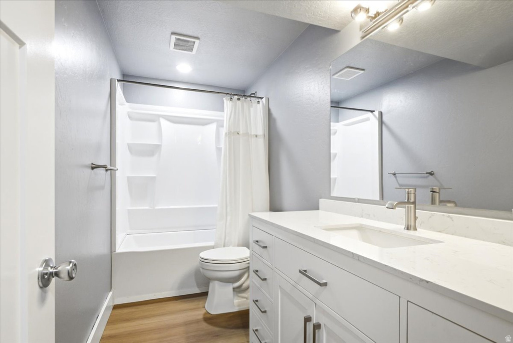 Contemporary bathroom featuring a white vanity with integrated sink, brushed nickel faucet, large mirror, and track lighting