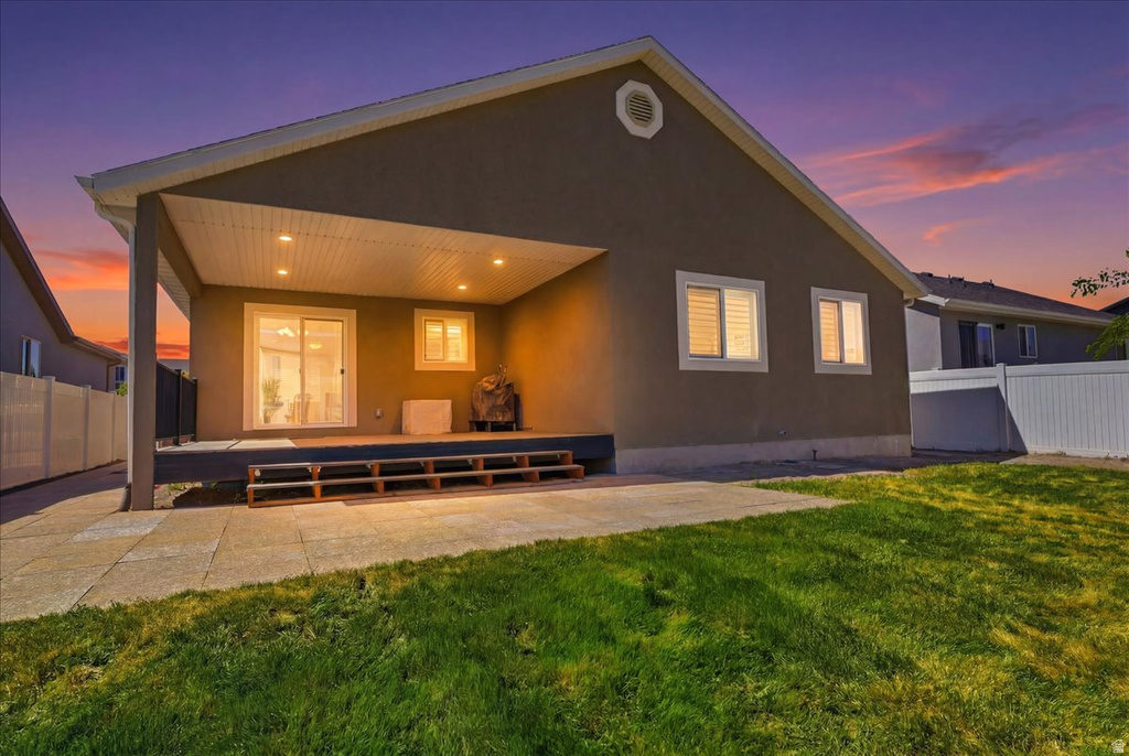 Expansive backyard featuring a covered patio, recessed lighting, concrete patio area, and a sliding glass door