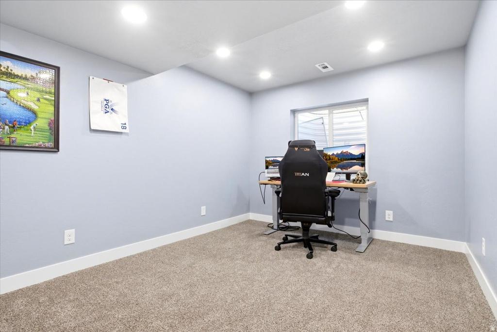 Carpeted room with recessed lighting and light blue walls