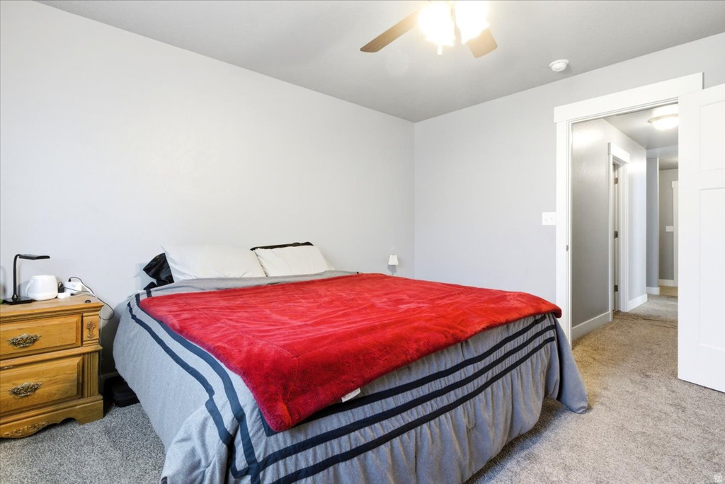 Bedroom featuring light grey walls and light grey carpet