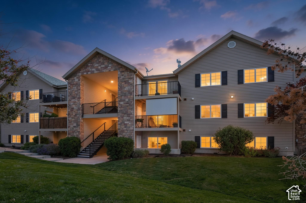 Multi-story residential building featuring stone veneer and horizontal siding