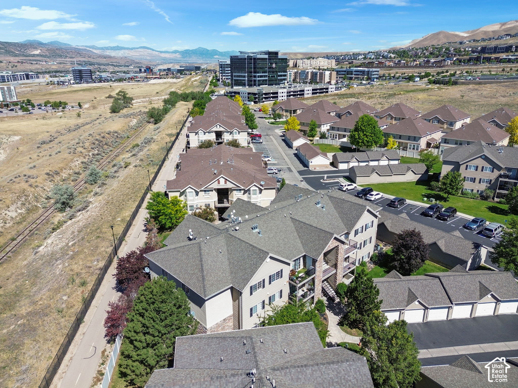 Residential complex with multiple buildings featuring pitched roofs and stucco exteriors