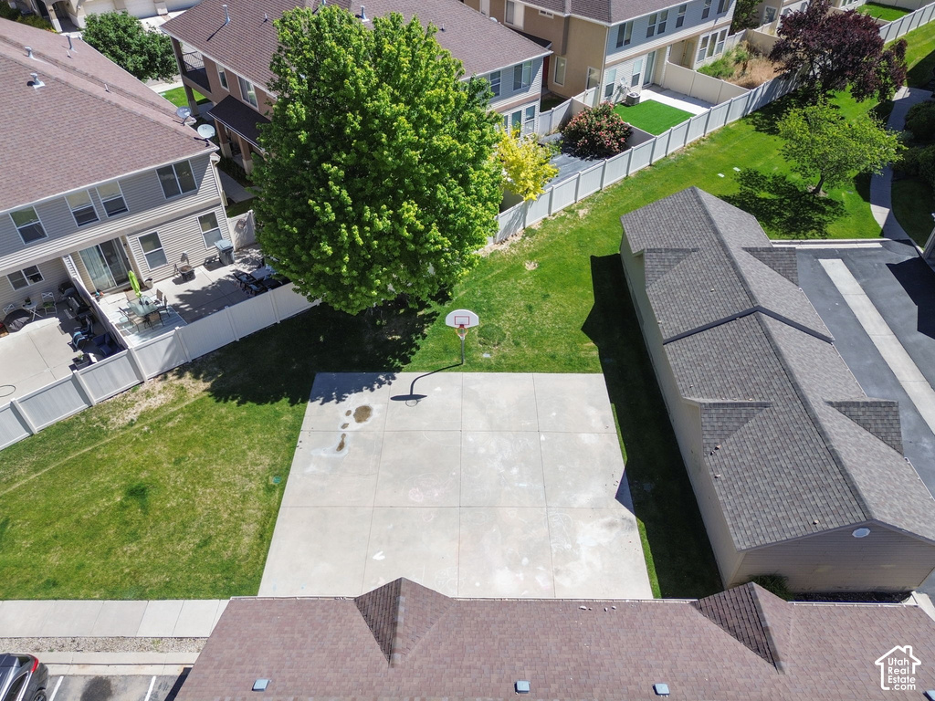 Expansive concrete pad suitable for recreation, surrounded by manicured green lawn