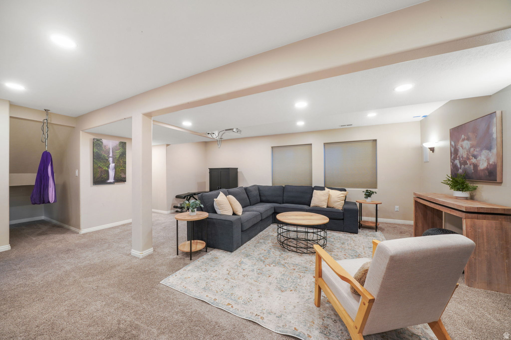 Spacious recreation area featuring recessed lighting, neutral carpeting, and a built-in wall niche