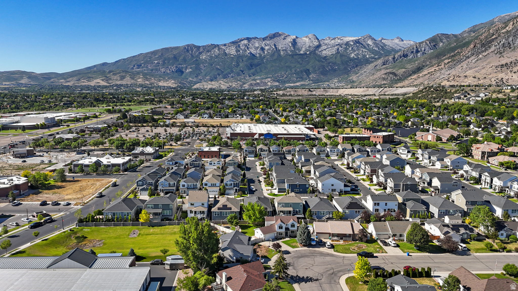 Expansive residential area featuring numerous single-family homes with diverse architectural styles, surrounded by mature trees and green spaces