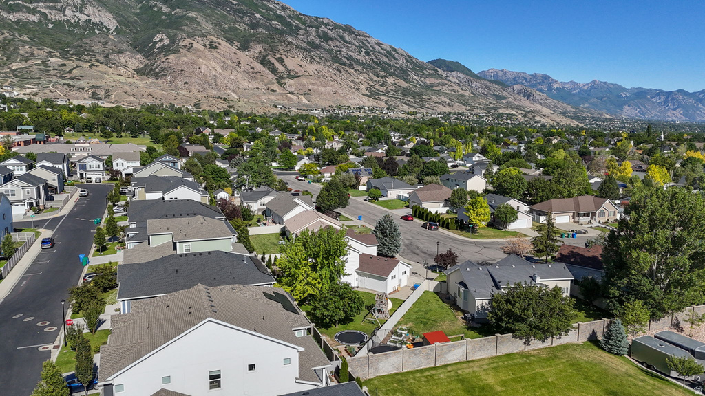 Residential neighborhood featuring mature landscaping and a mountainous backdrop