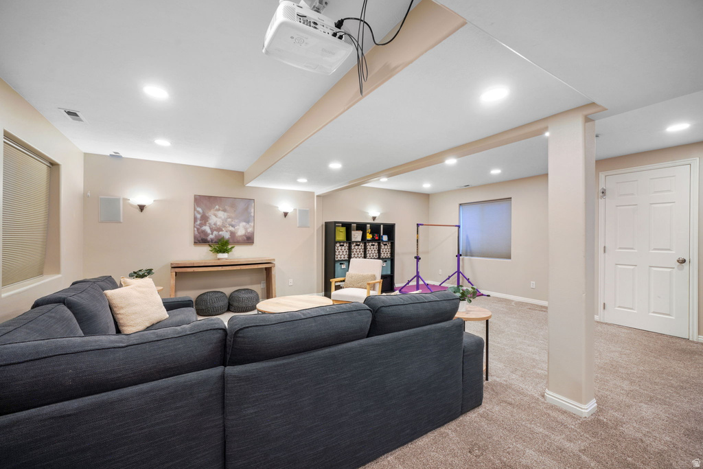 Finished room featuring recessed lighting, carpet flooring, a built-in projector, and wall-mounted speakers
