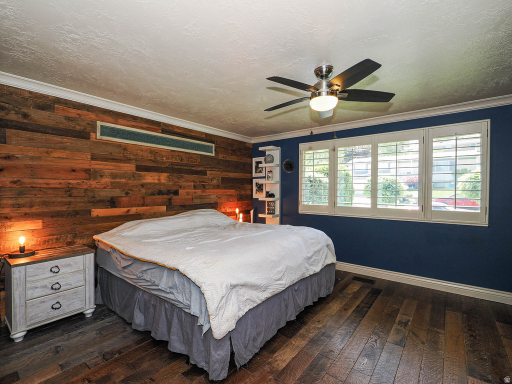 Wood-finish plank flooring complements the accent wall featuring horizontal wood paneling