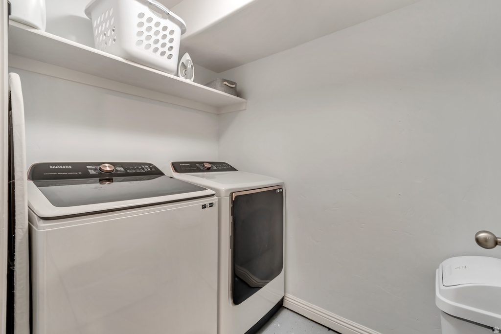 Dedicated laundry area featuring a white top-load washer and front-load dryer