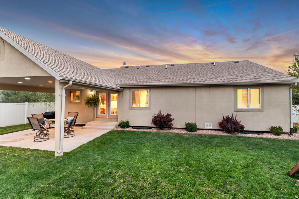 Spacious backyard featuring a covered patio with recessed lighting, a concrete patio surface, a manicured lawn, and mature landscaping