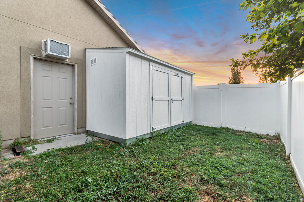 Private outdoor space featuring a white storage shed and perimeter fencing