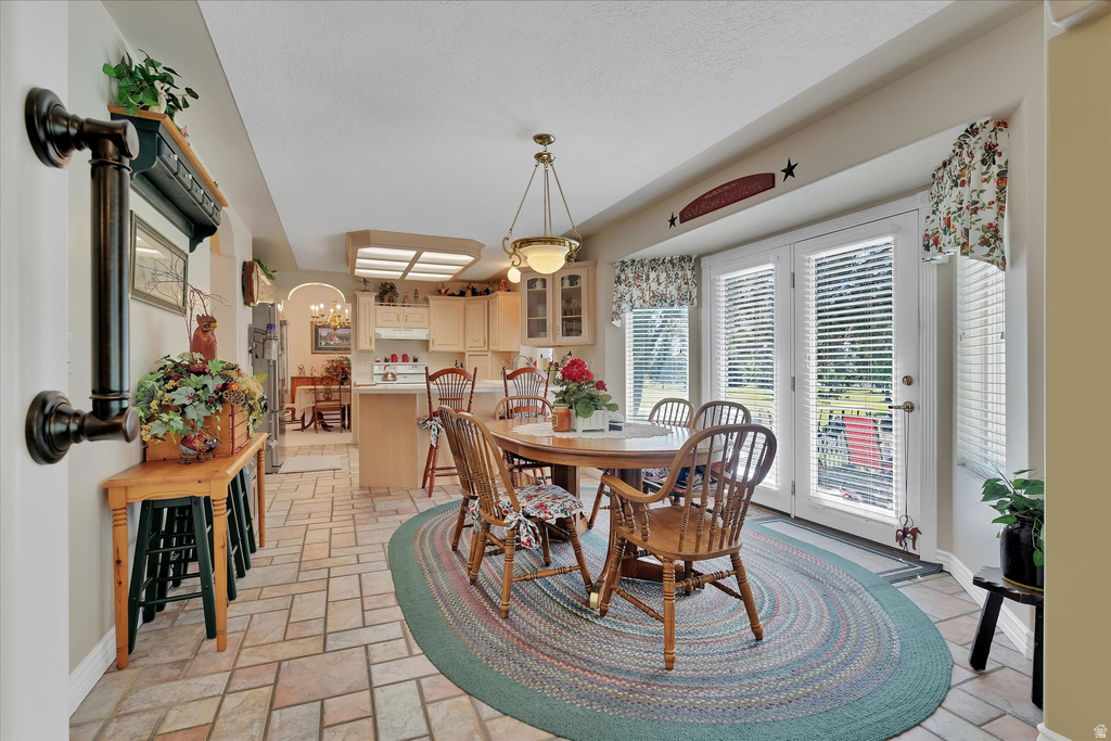Kitchen and dining area featuring durable tile flooring in a varied pattern