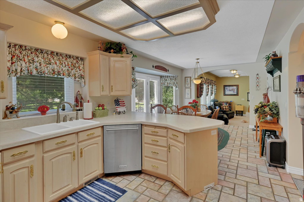 Kitchen with light cabinetry, a double basin sink, and stainless steel dishwasher
