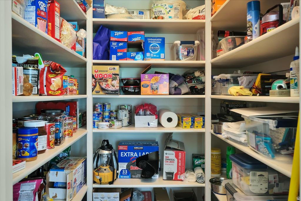 Built-in pantry shelving featuring multiple tiers of white shelves, offering extensive storage capacity
