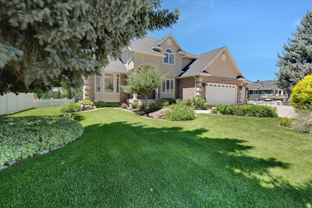 Two-story residence featuring a combination of brick and stucco siding