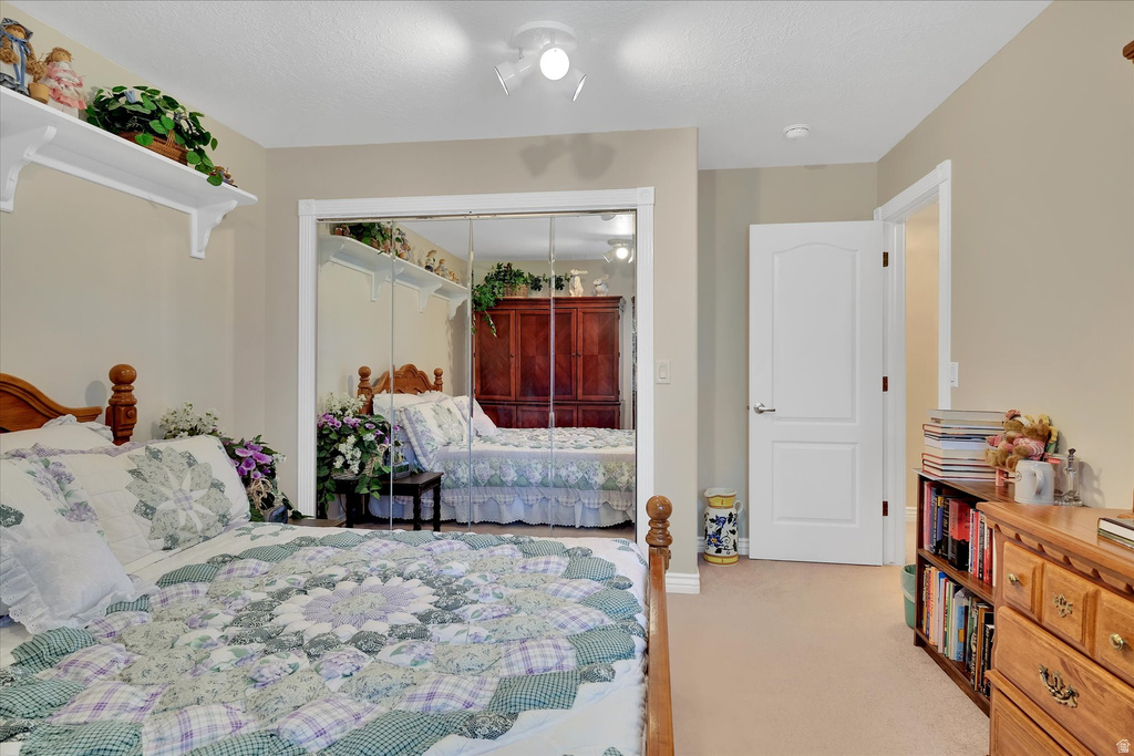 Neutral-toned room featuring light beige carpeting and white baseboards