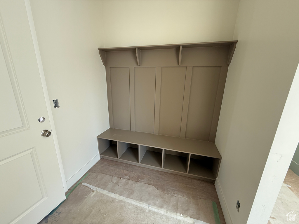 Built-in hall tree with a top shelf, paneled backing, integrated bench, and six storage cubbies