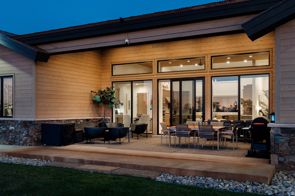 Expansive outdoor patio featuring a concrete surface and a stone facade