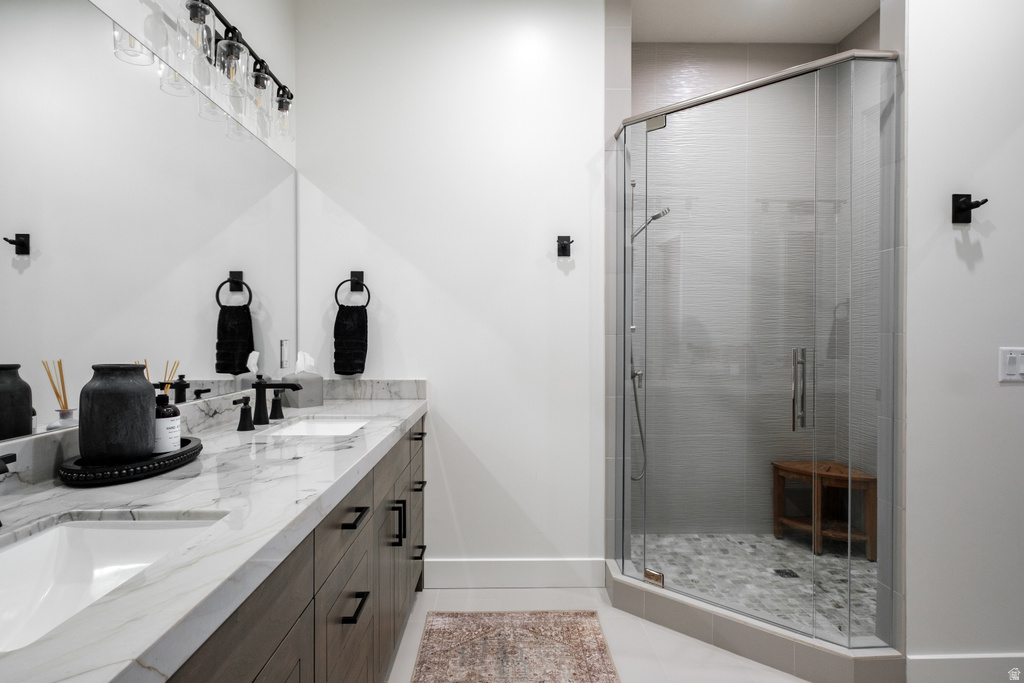 Dual vanity with a white marble-finish countertop, undermount sinks, and dark wood-finish cabinetry