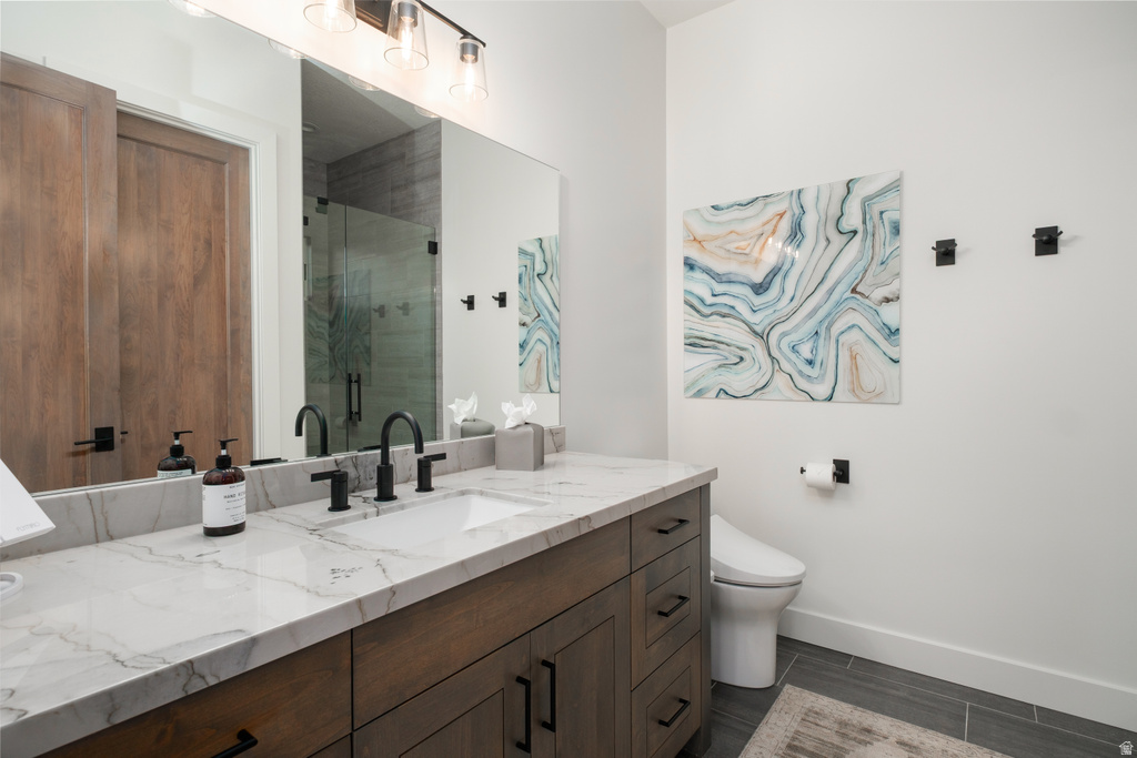 Modern bathroom featuring a wood-finish vanity with a single undermount sink