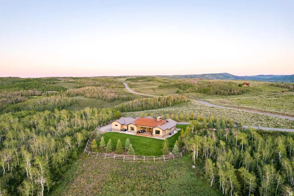 Expansive property featuring a stone and stucco residence with a prominent chimney
