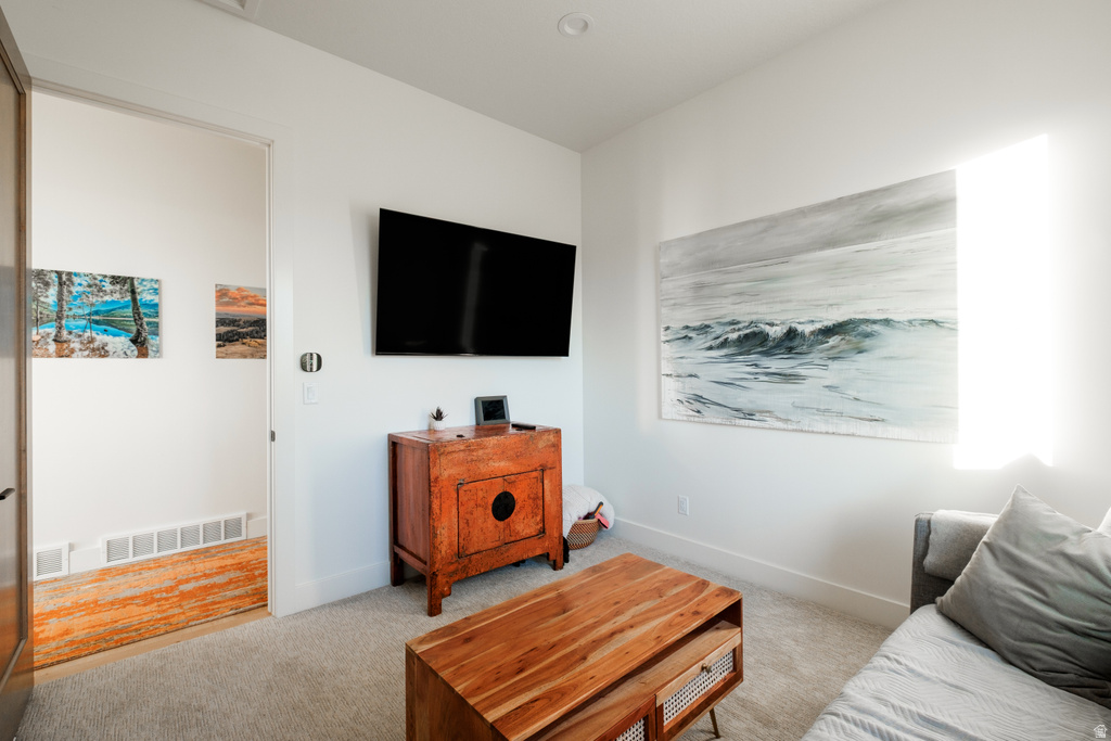 Carpeted room with white walls and recessed lighting